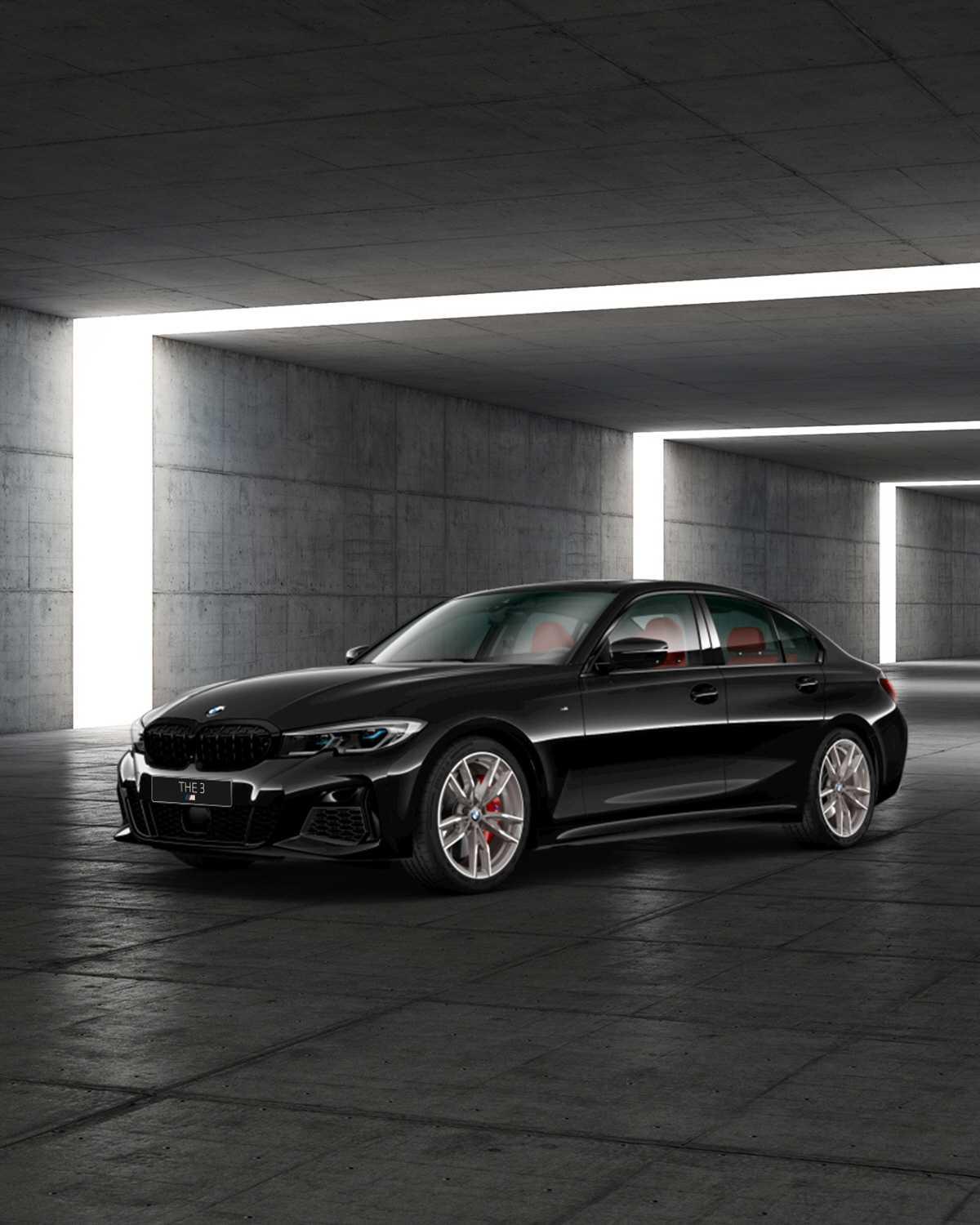 A black 2022 BMW M340i xDrive in a concrete showroom
